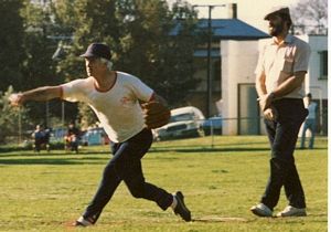 Played with no uniforms.  Check out the umpire, jeans, smokes in the pocket and the cap!